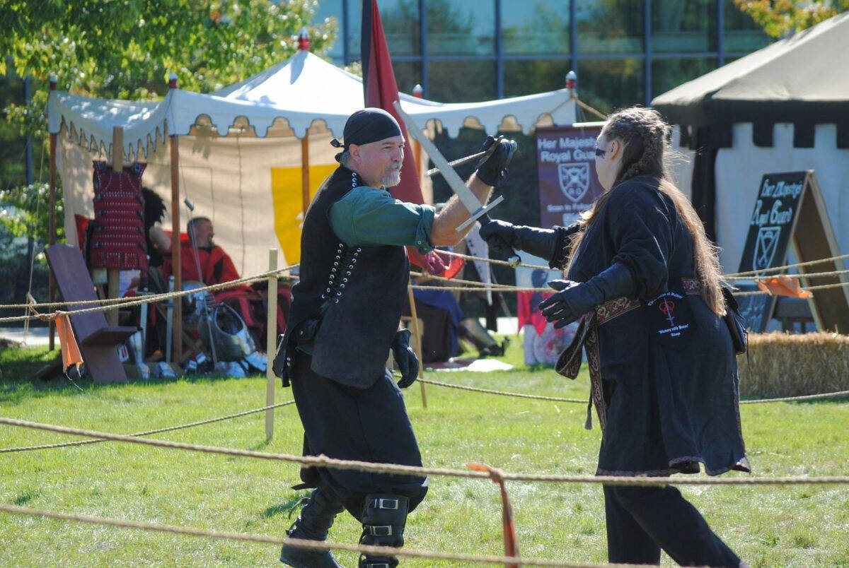 Two people fighting with swords